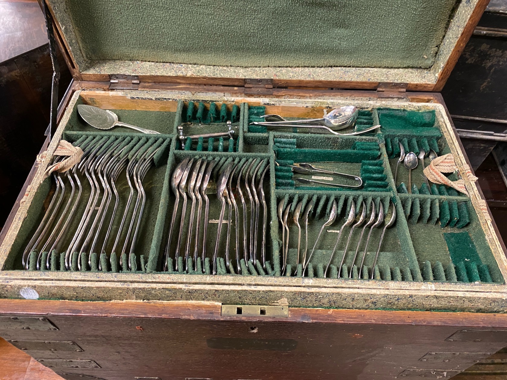 A Victorian iron bound oak silver chest with three interior trays housing assorted silver plated flatware, width 64cm, depth 41cm, height 51cm
